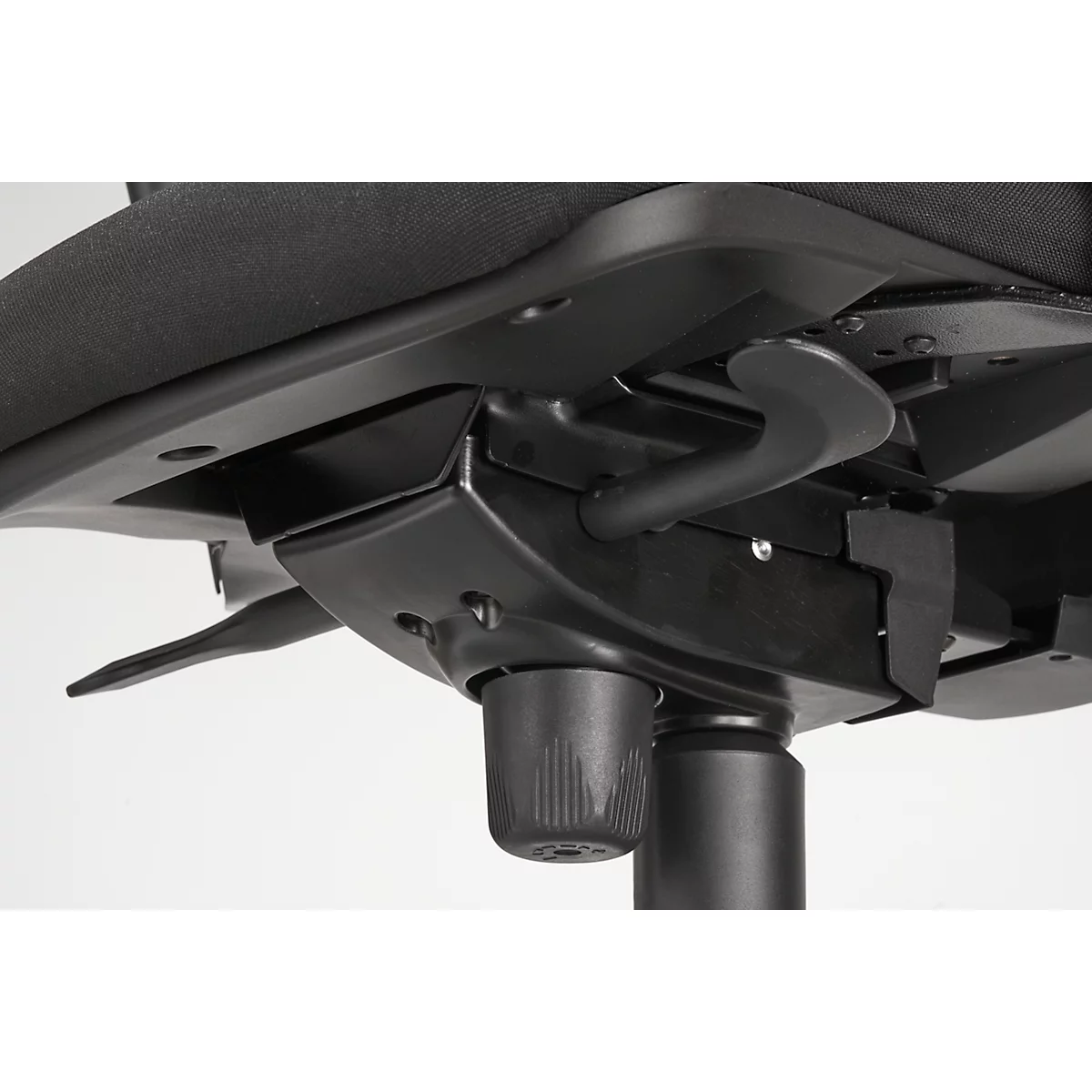 Close-up of the underside of an office chair, black, with controls and support mechanism.