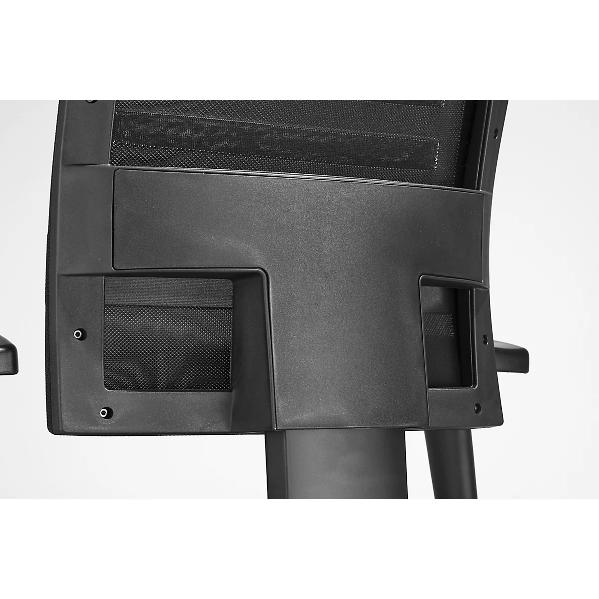 Close-up of the back of a black office chair with rectangular cutouts.