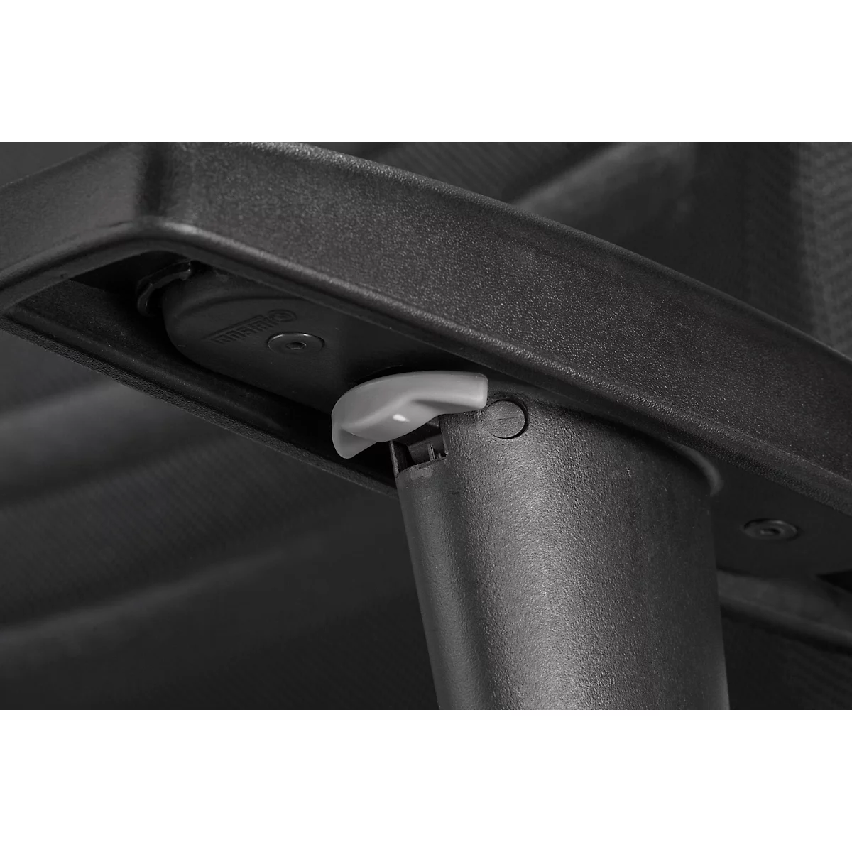 Detail shot of a grey lever on a chair with a black structure.