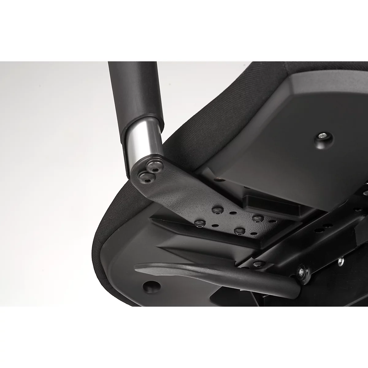 Detailed view of the mechanics of a black office chair. Screws and metal brackets are visible.