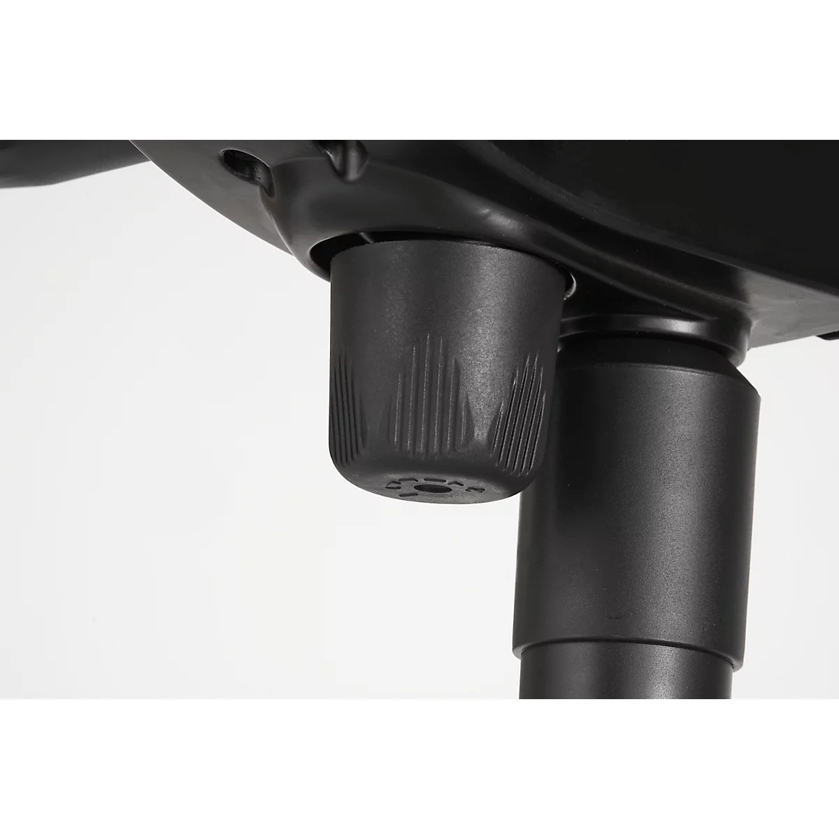 Close-up of a black rotary knob on an office chair. The knob has grooved surfaces that allow for adjustment.