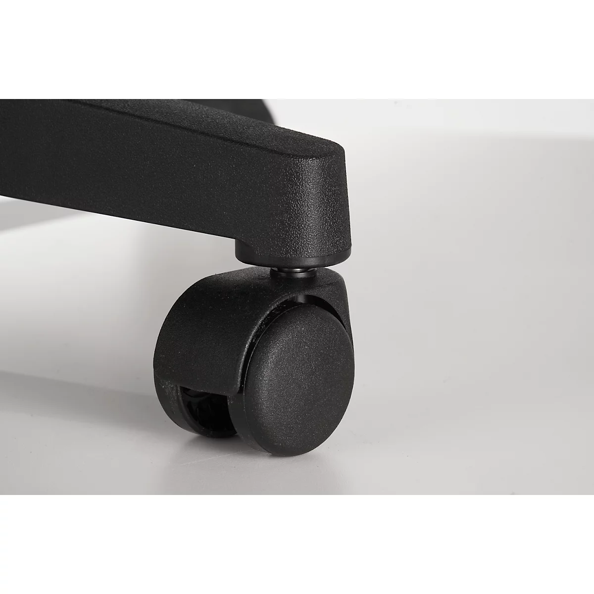 Close-up of a black office chair caster on a white background.