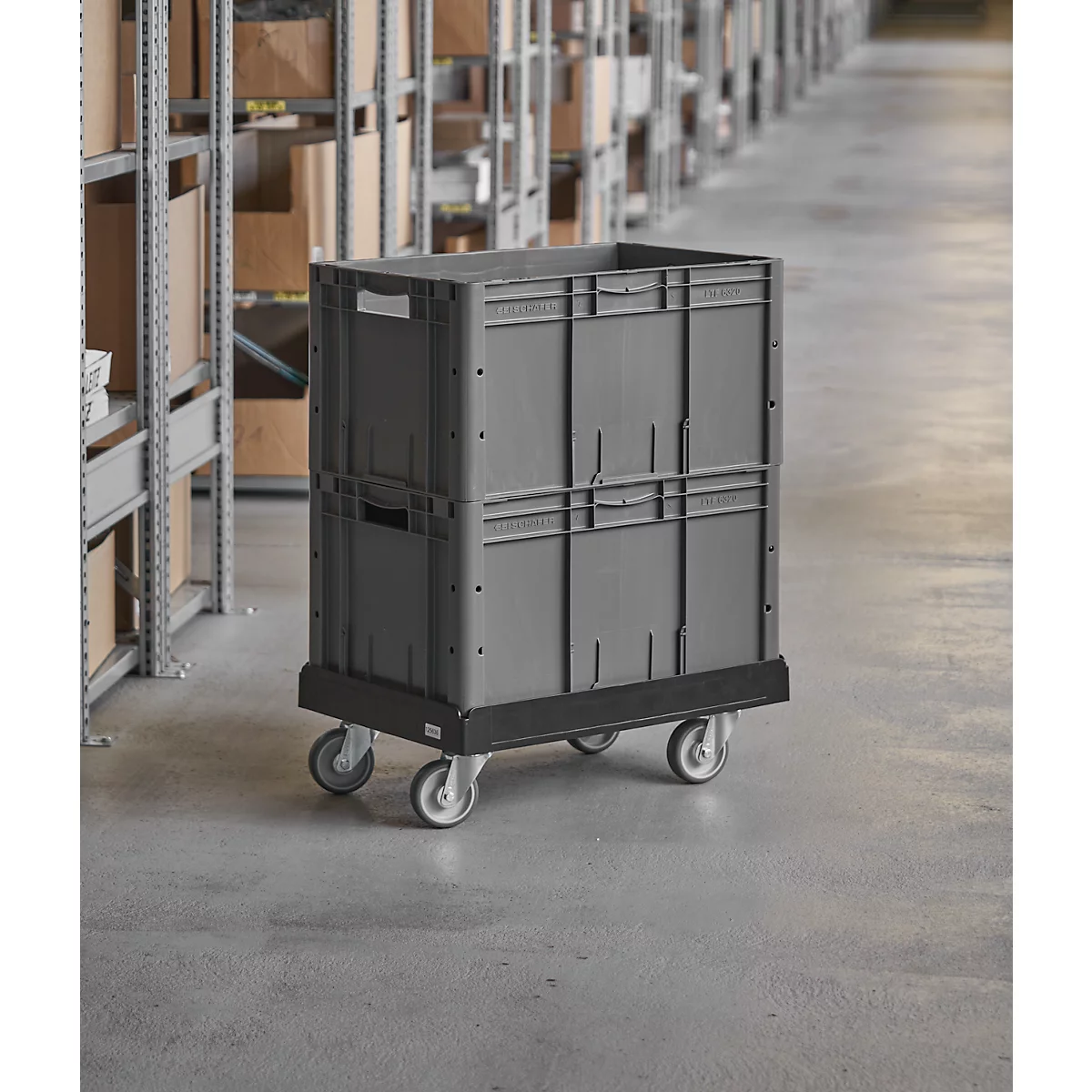 Gray transport container on wheels in a warehouse. Surrounded by shelves with boxes.