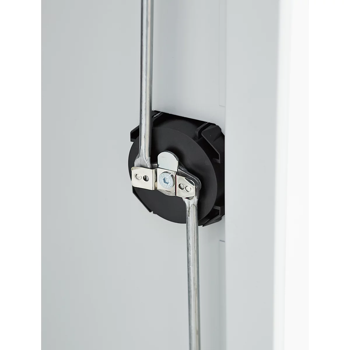 Detailed close-up of a mechanical device. Gray metal levers on black, cylindrical element against a white background.