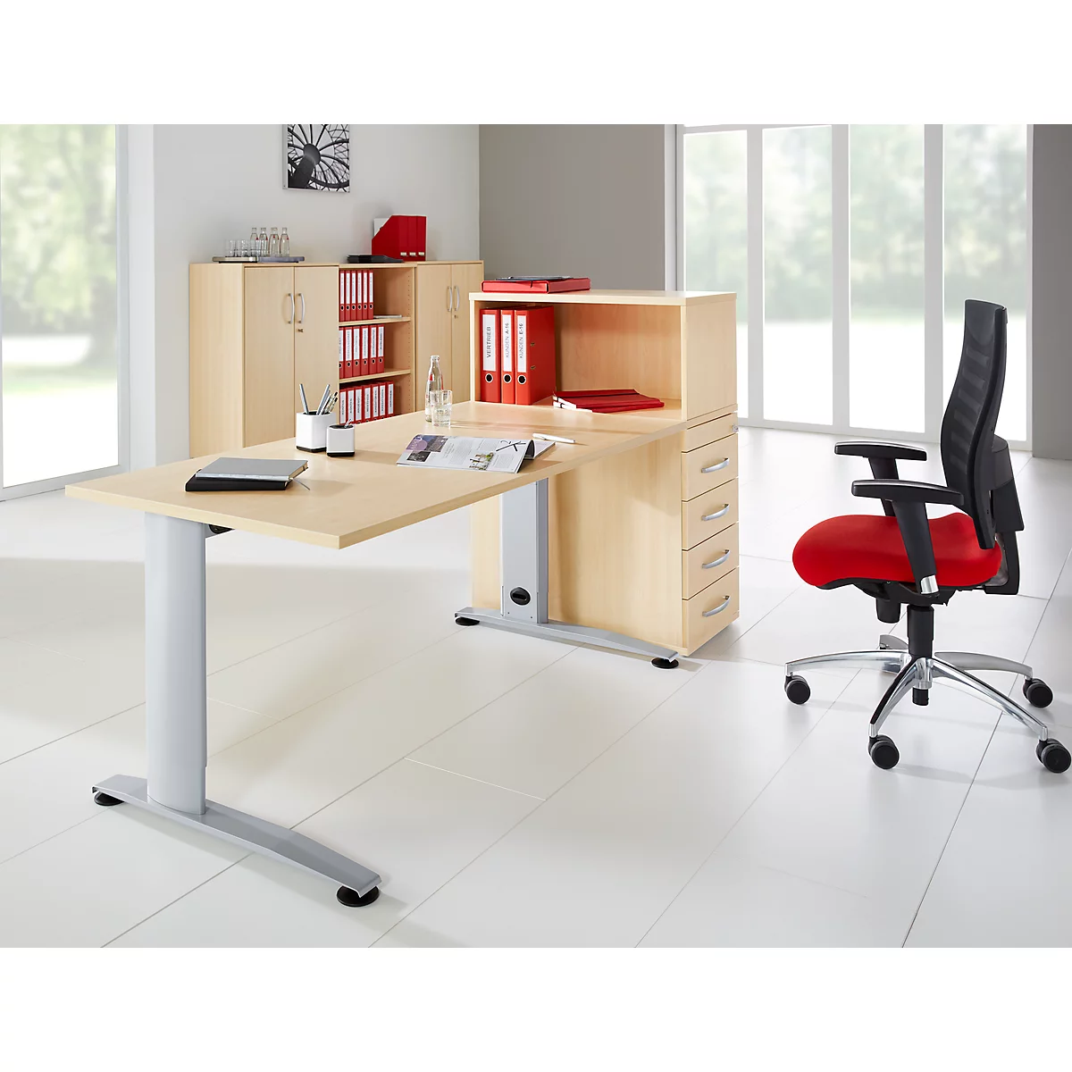 Office set up with desk, swivel chair and filing cabinets in light wood. Documents are on the desk.