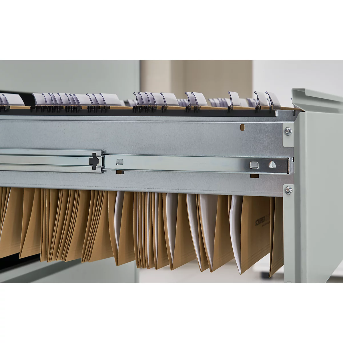 Close-up of a hanging file cabinet with brown file folders and index tabs.