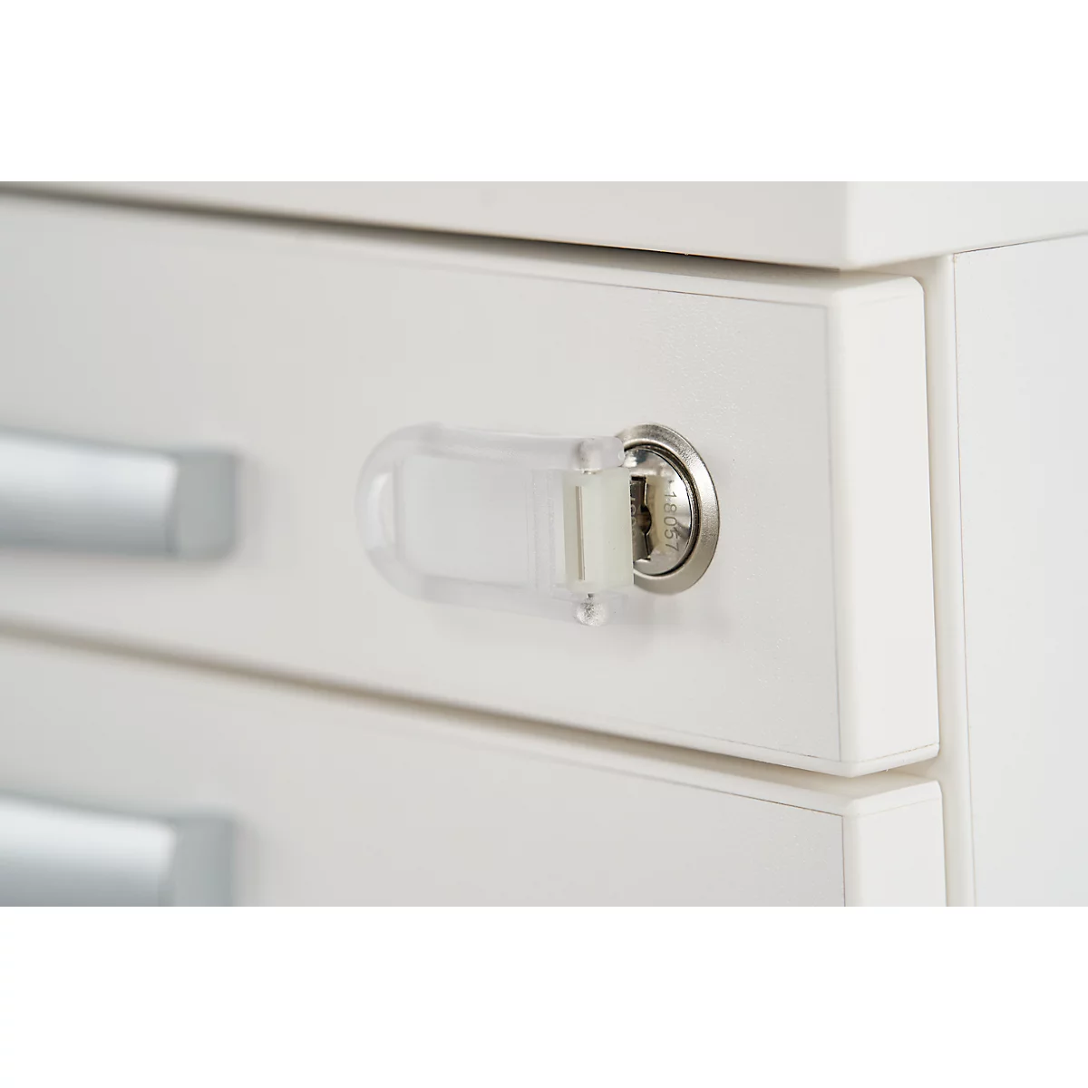 Close-up of a white cabinet with lock and child safety.