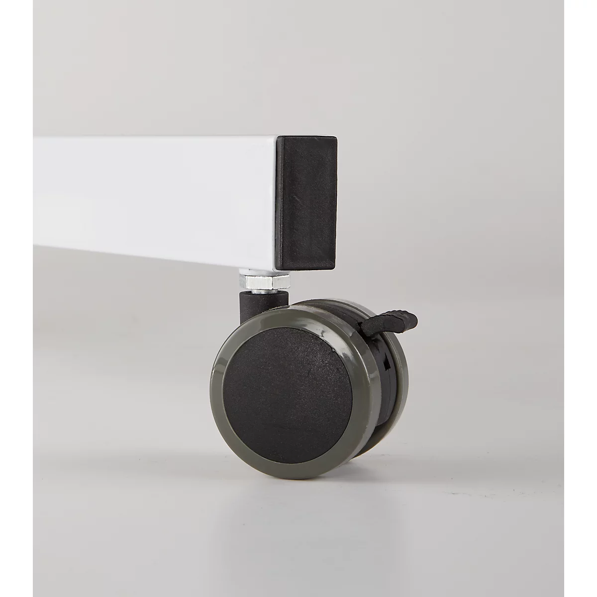 Close-up of a white furniture leg with black foot and gray caster. The caster's locking lever is visible.
