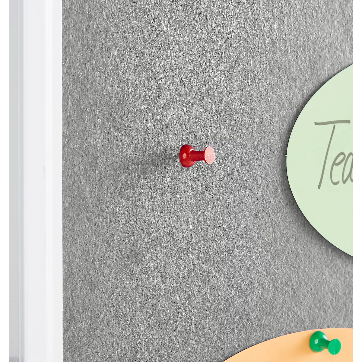 A red push pin attached to a gray felt surface.