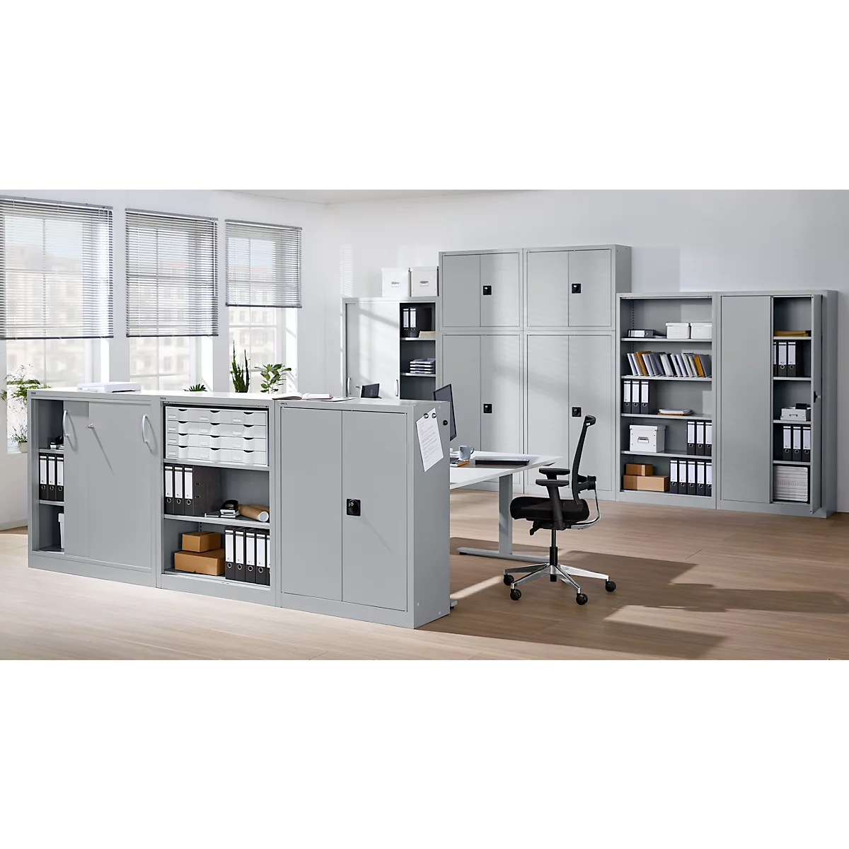 Office featuring gray cabinets, desk, and chair. Visible are file folders and office supplies.