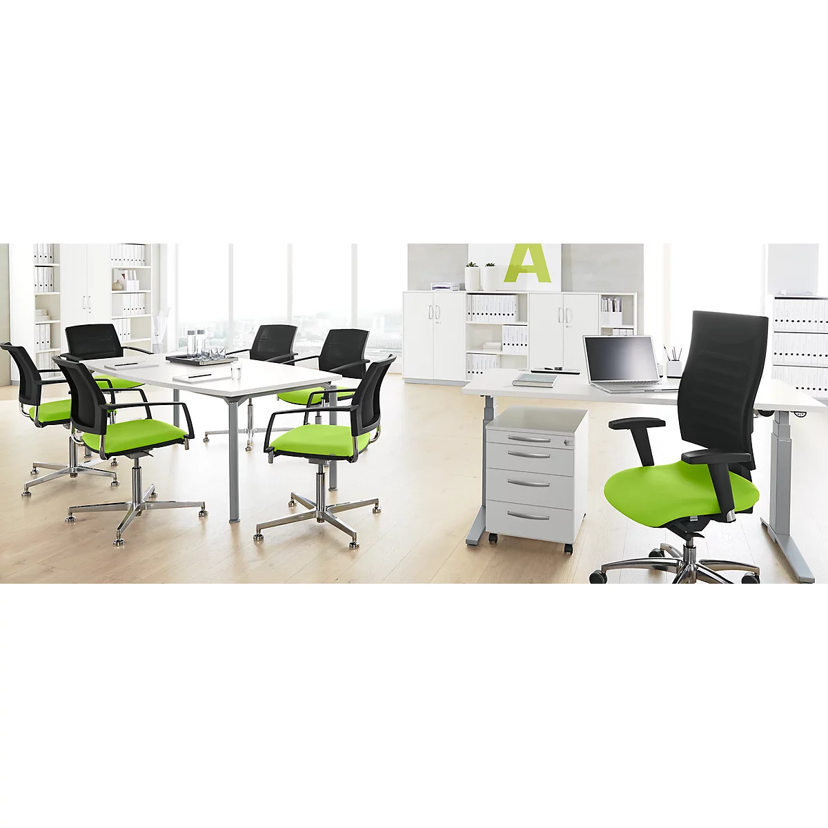 Office with light green office chairs. A table with a laptop and several chairs.