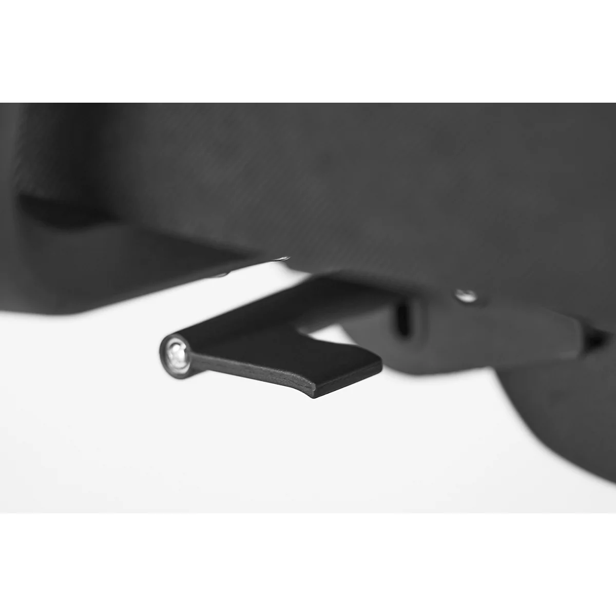 Close-up of a black lever protruding from a dark fabric surface. The lever is slightly curved.