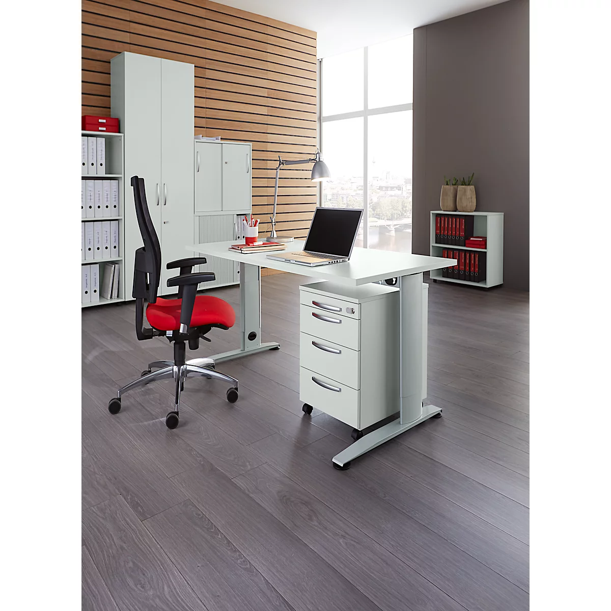 Bright, modern workspace with desk, chair, cabinet and laptop.