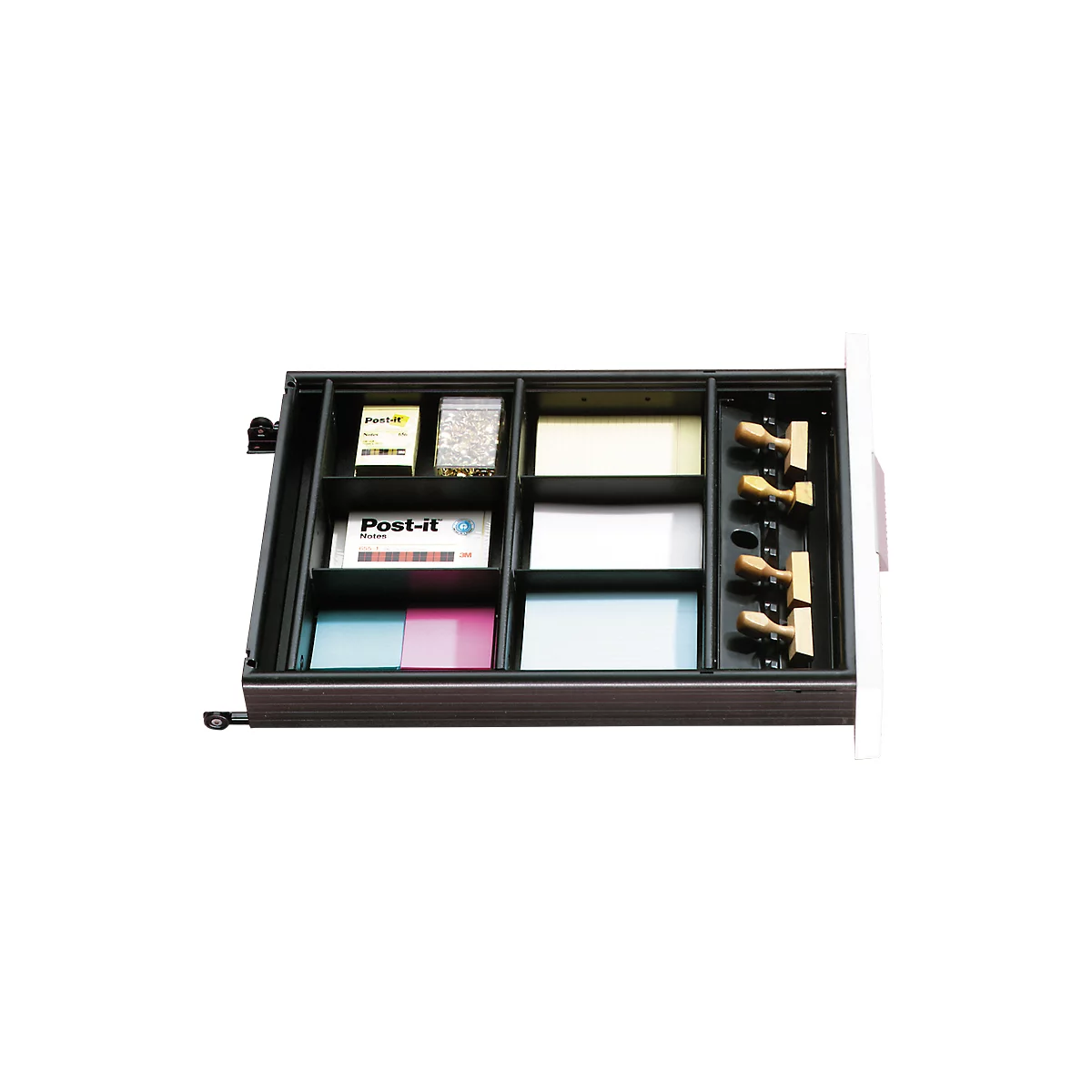 Open drawer insert with office supplies: sticky notes, stamps, staples, notepaper.
