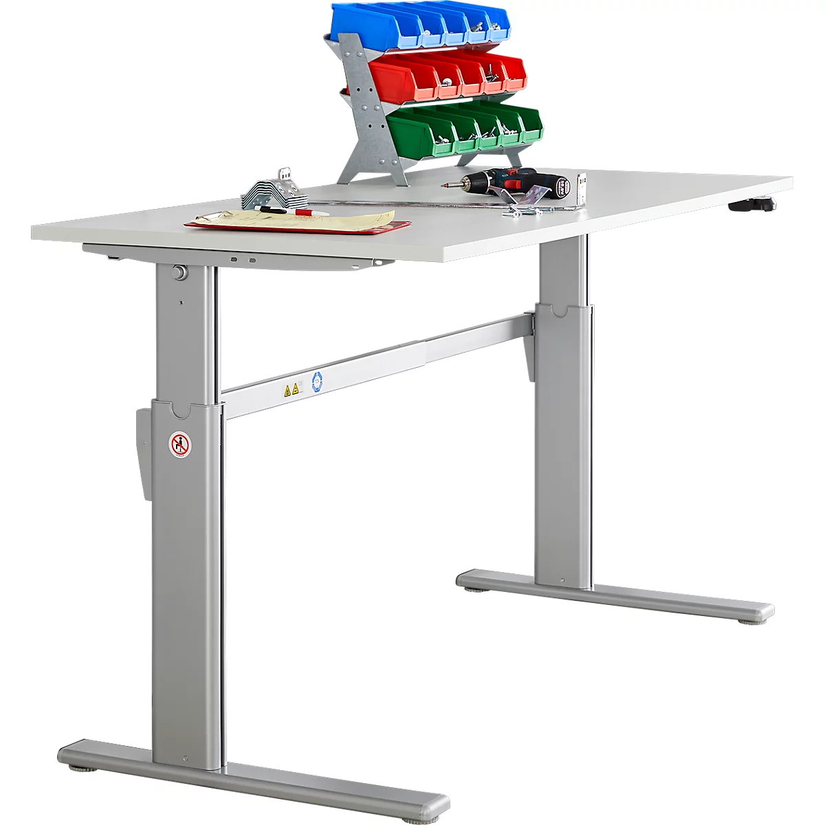 A height-adjustable desk with tools. On the desk are screw boxes, tools and a screwdriver.