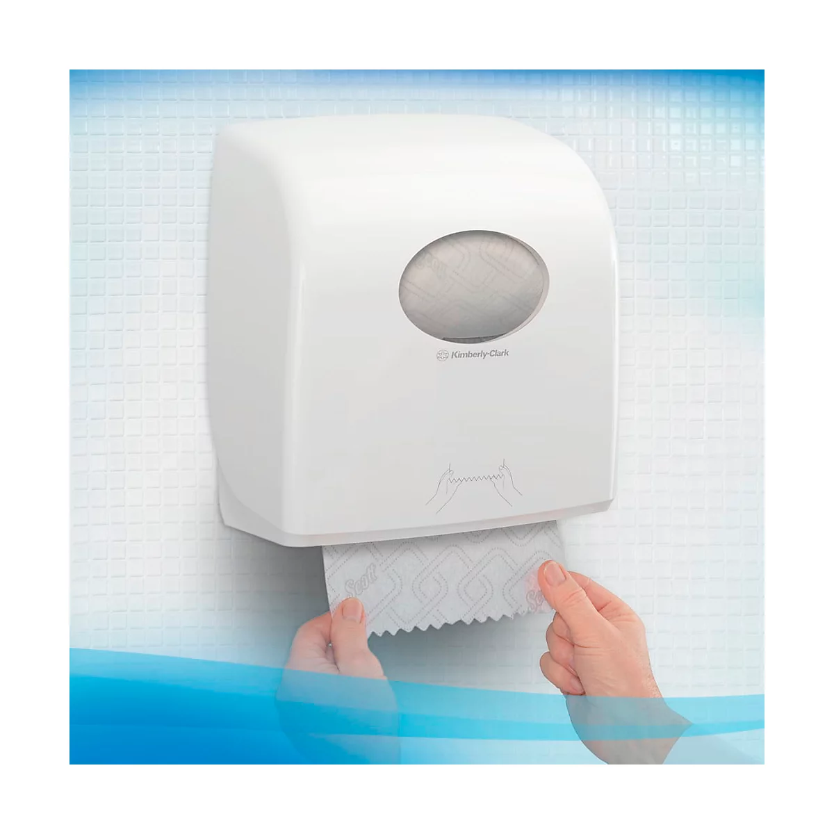 Weisse Papierspender-Box an der Wand. Hände ziehen Papiertücher heraus.