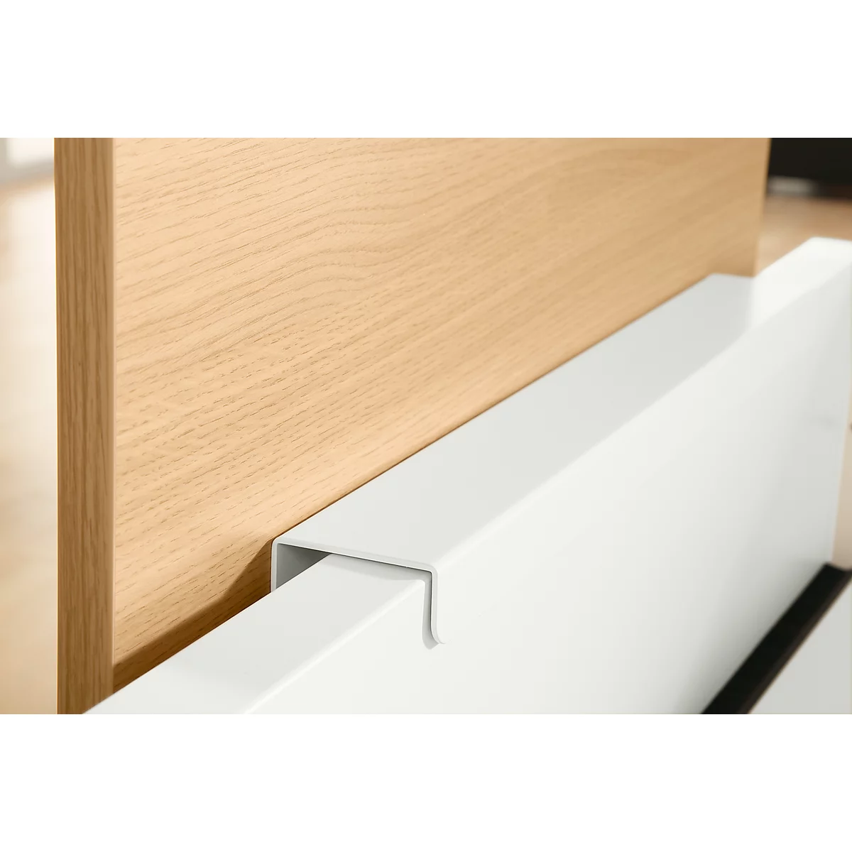 Close-up: Wooden panel meets white, angular metal. The surfaces are smooth and cleanly finished.