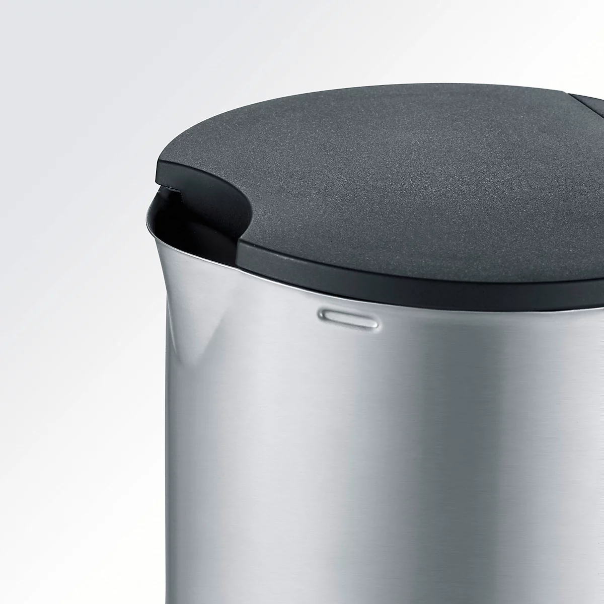 Close-up of a kettle with a stainless steel body and black lid.