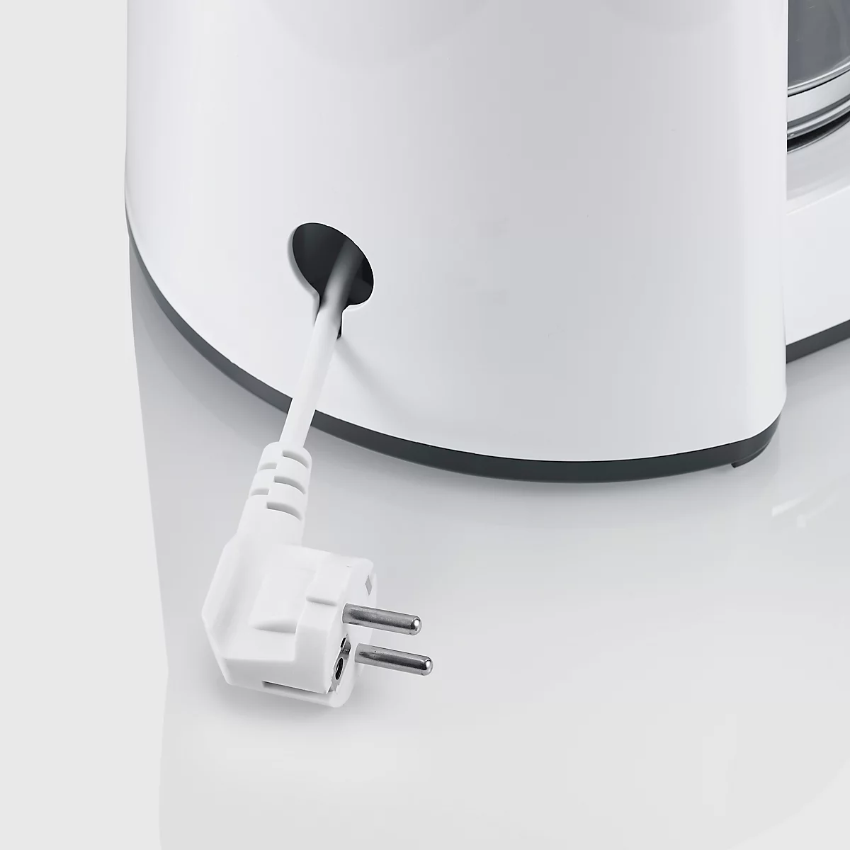 Naheaufnahme eines weissen Küchengeräts mit Stromkabel und Stecker.
