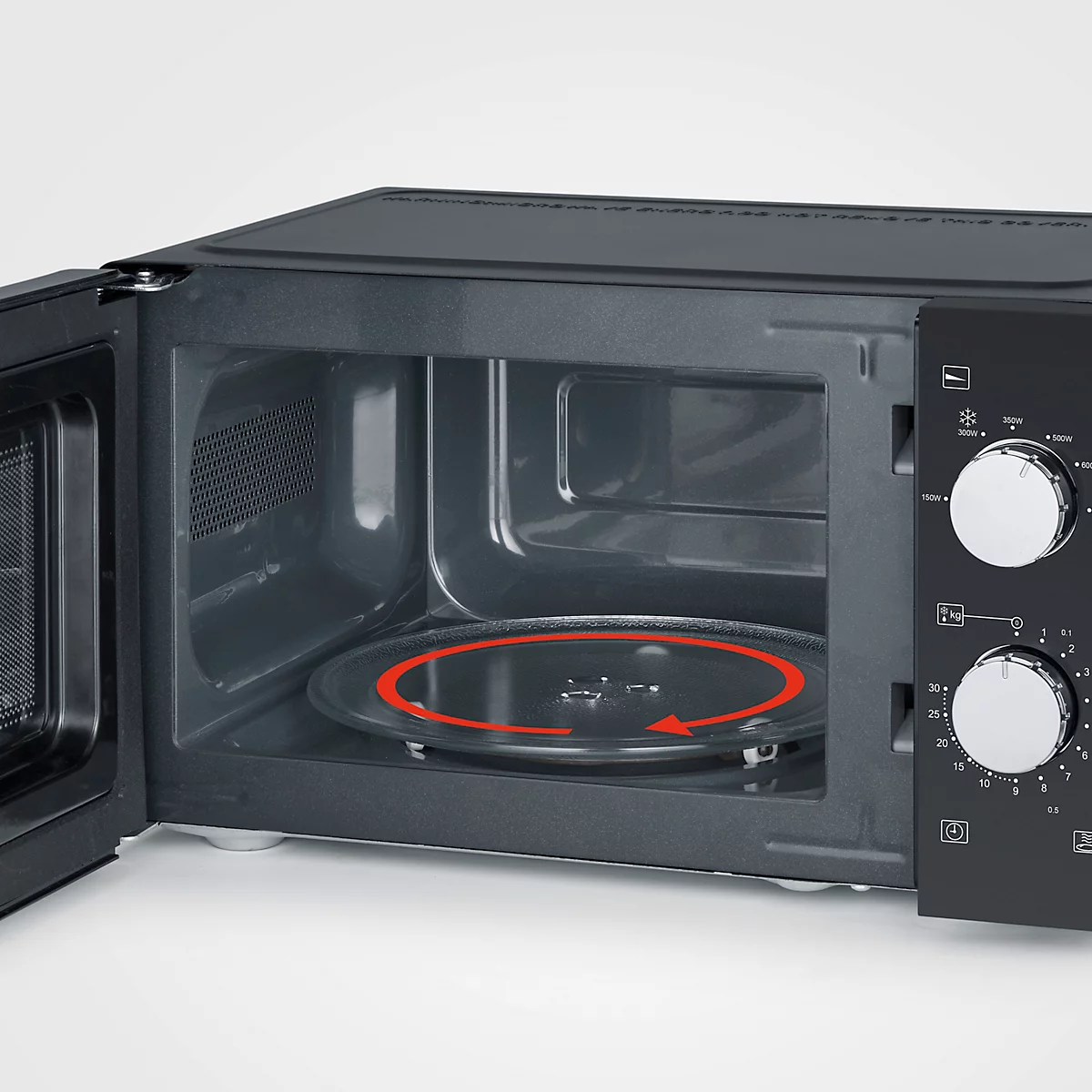A black microwave with the door open. A red arrow is turning on a glass plate inside.