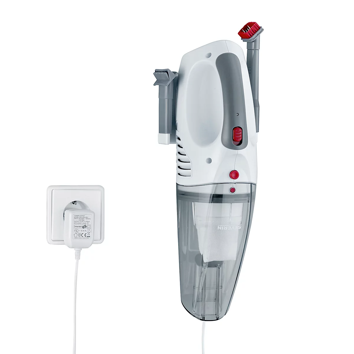A white hand vacuum hangs on the wall, with charger in outlet.