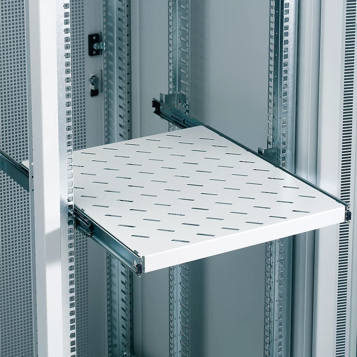 White shelf in a server cabinet. Provided with slotted holes, extended on rails.