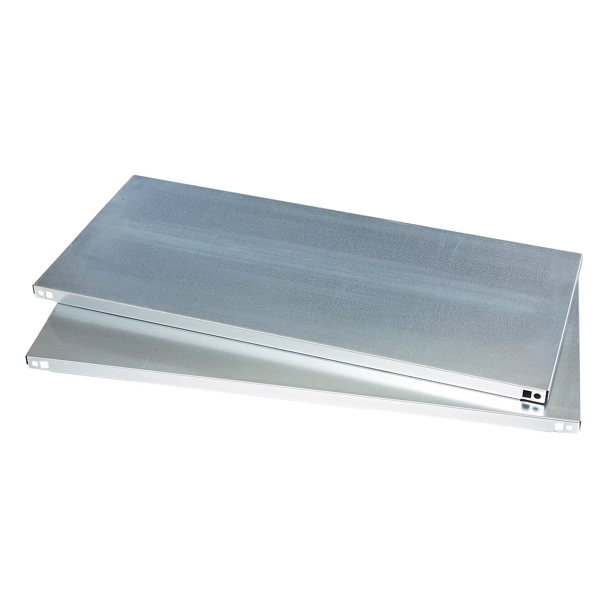 Two metallic shelf boards are lying on top of each other. The metallic surface reflects the light.