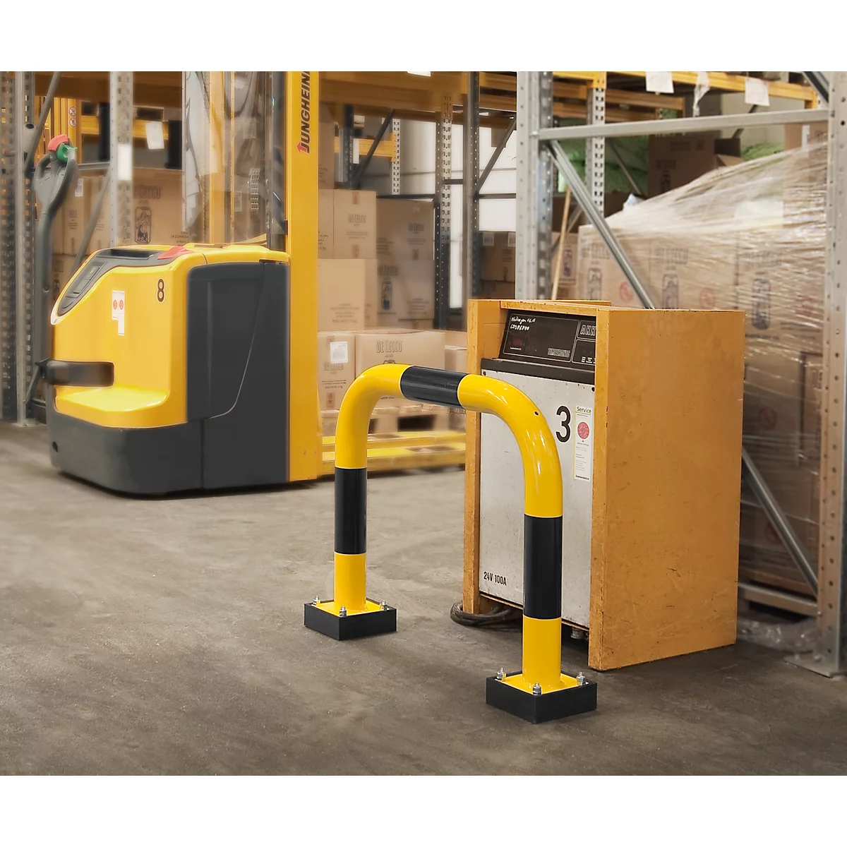 Yellow safety barrier at a warehouse shelf. A yellow forklift in the background.