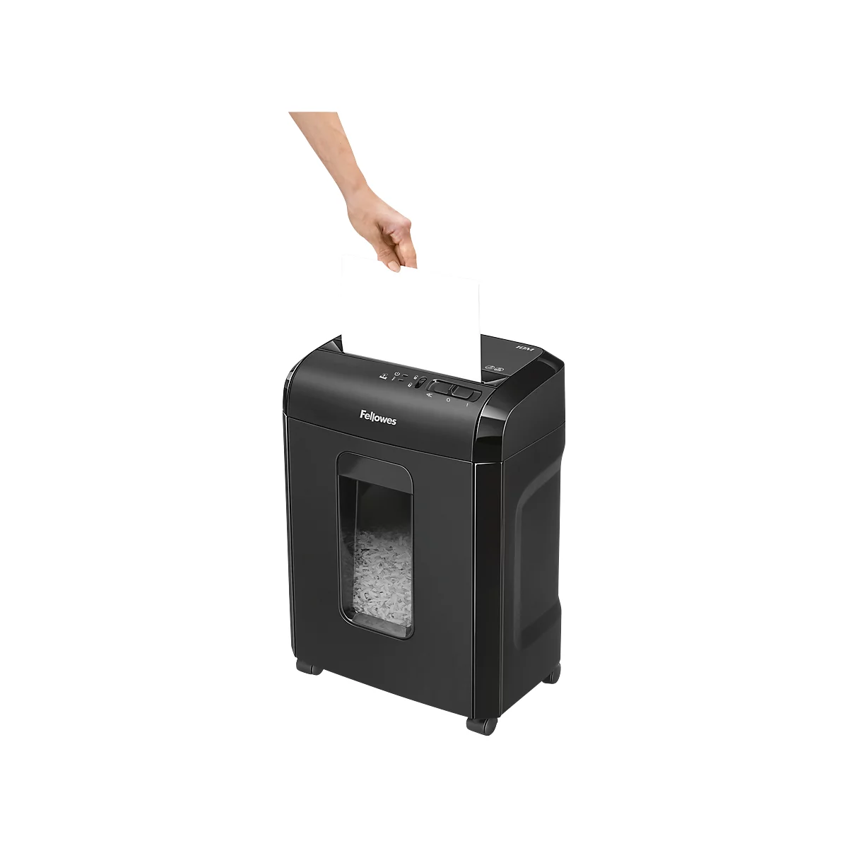 A hand feeding paper into a black paper shredder. Shredded paper can be seen in the window.
