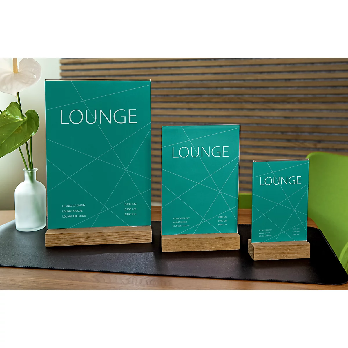 Three table stands made of green glass with a wooden base. Each says 'LOUNGE' in white.