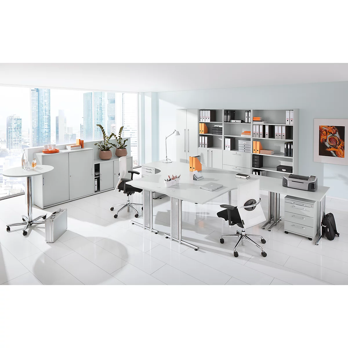 Bright office space with white furniture, desks, chairs and a window overlooking a city.