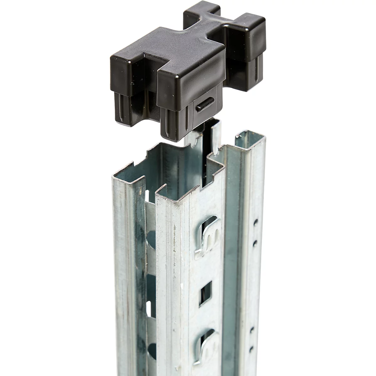 Black plastic part being attached to a metal profile rail. Visible in detail: grooves and hooks for fixing.