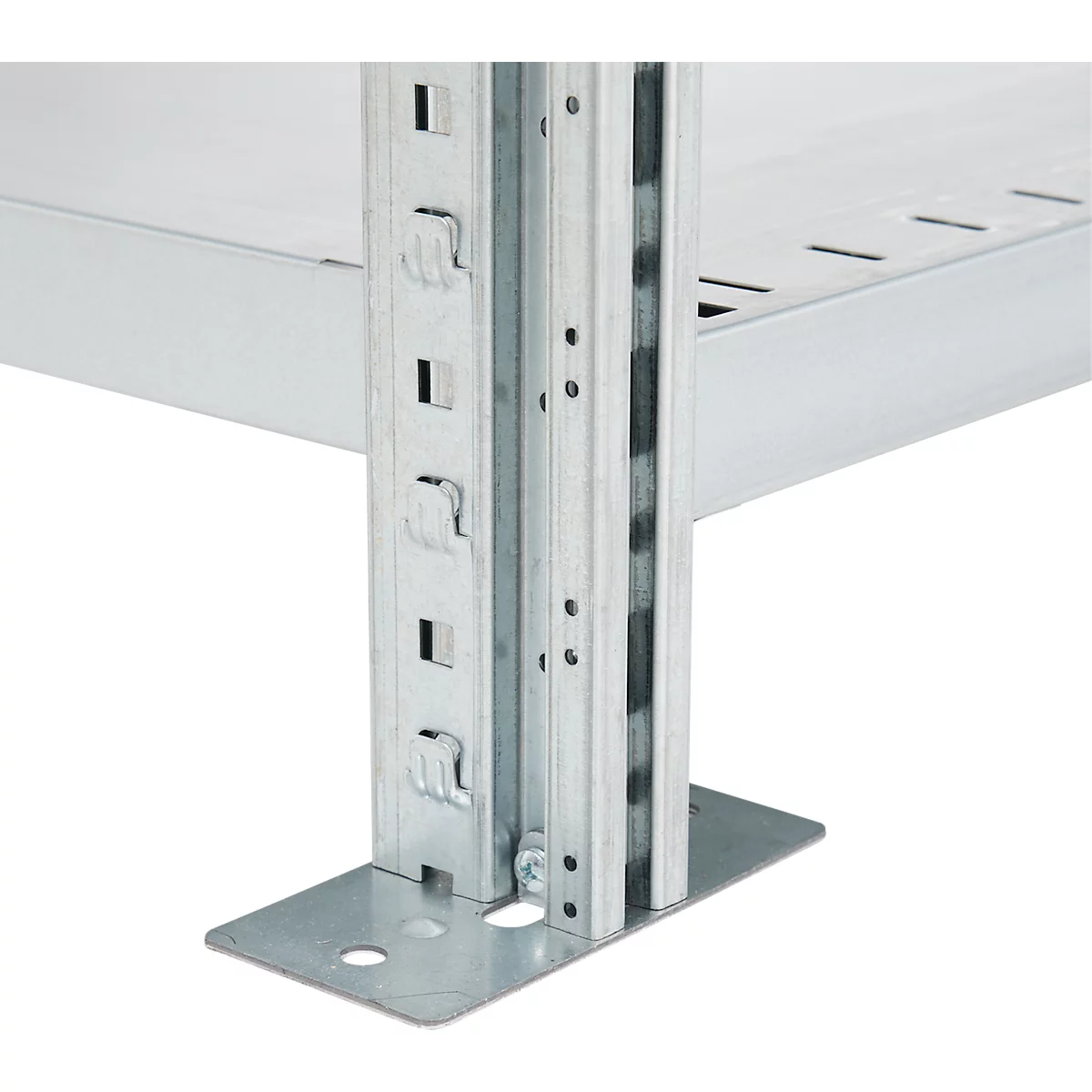 Close-up of shelving construction with metallic columns, holes and brackets.