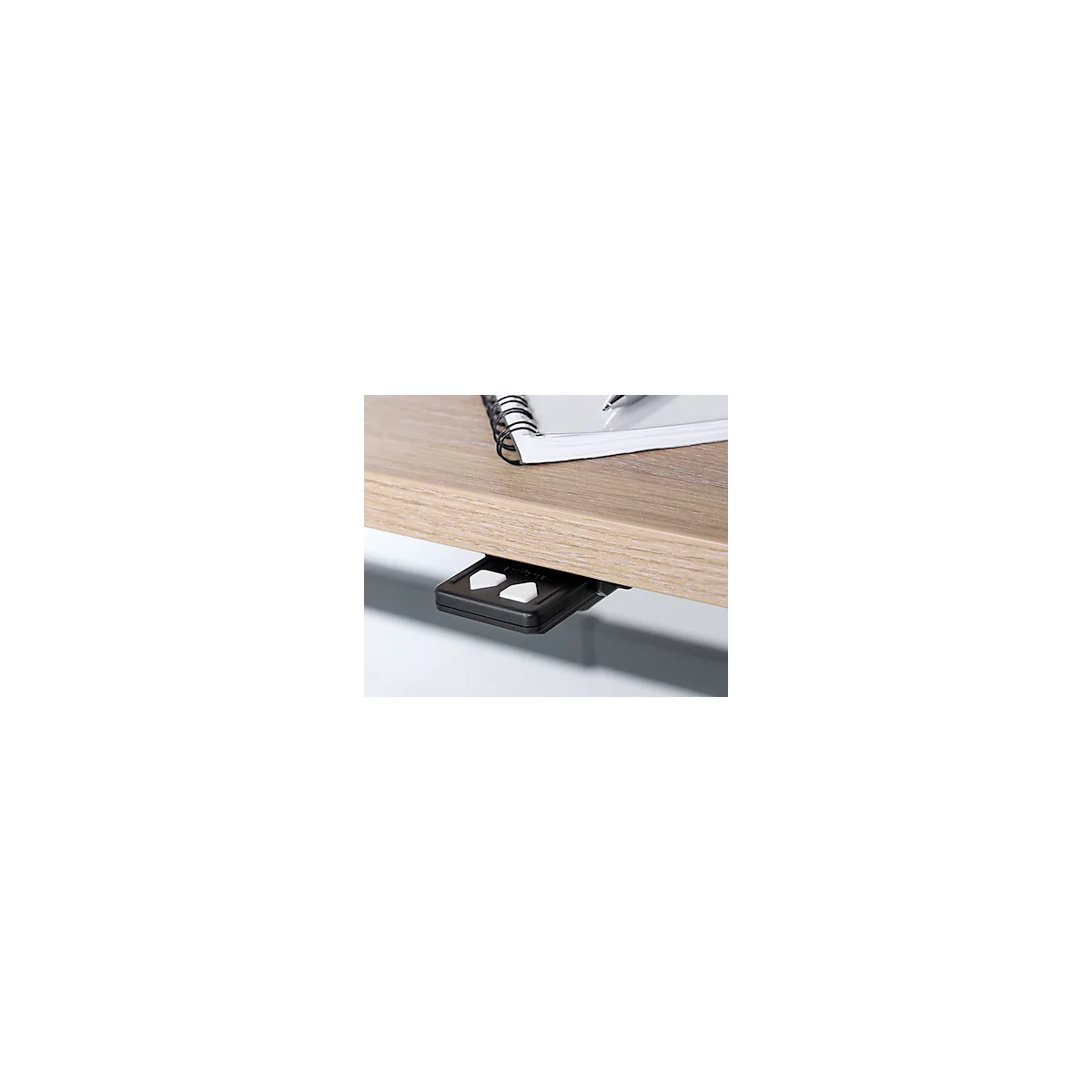 Wood-grained desk. Underneath a black control with white arrow keys.