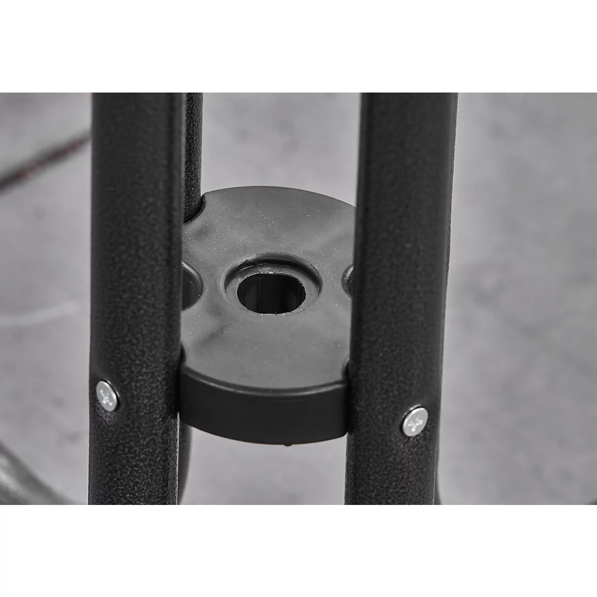 Detail shot: Black metal bars with screws, connected by a round holder.