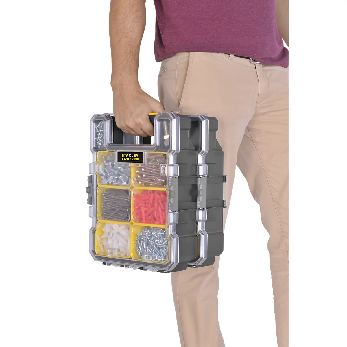 A person is carrying a toolbox with screws and dowels. The box is transparent and labeled.