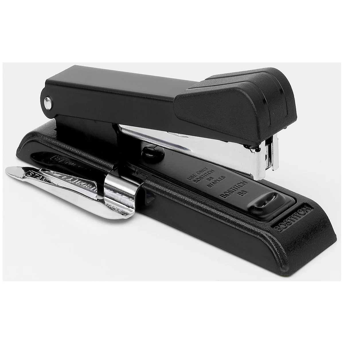 A black stapler with silver metal parts, lying on a white background.