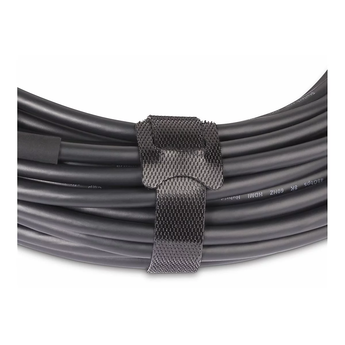 Gros plan d'un câble HDMI noir enroulé avec une sangle velcro.