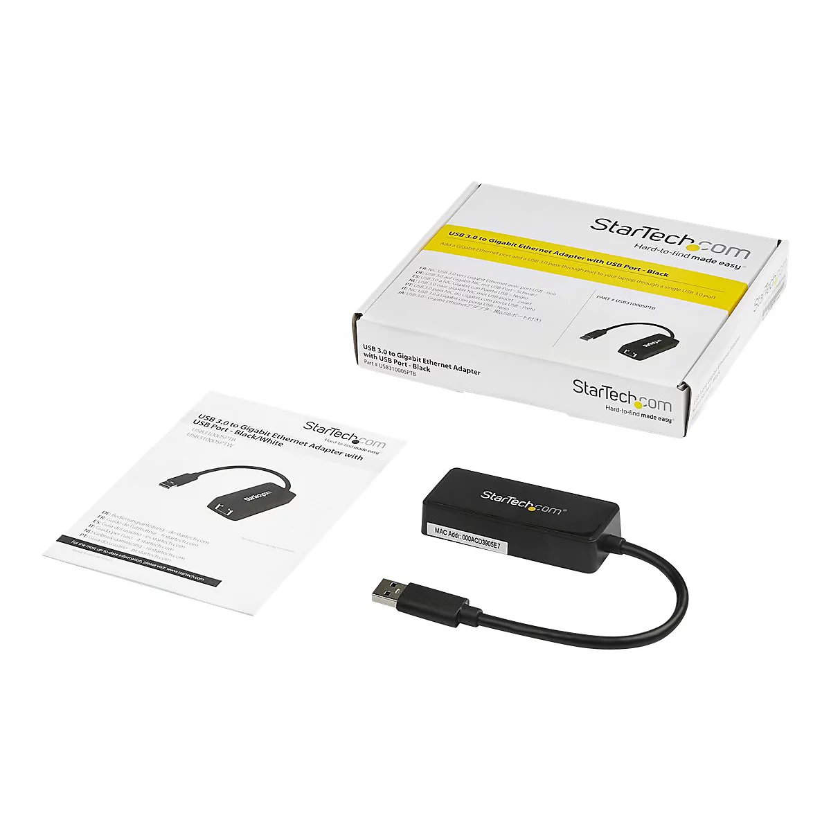 Adaptateur USB vers Ethernet noir avec emballage, manuel d'utilisation et fond blanc.