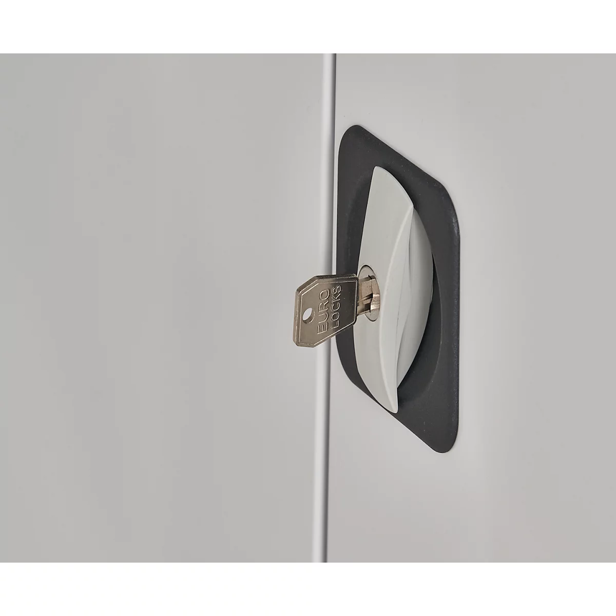 Close-up of a cabinet handle with a key inserted in the lock. The key reads "Ferco Locks".