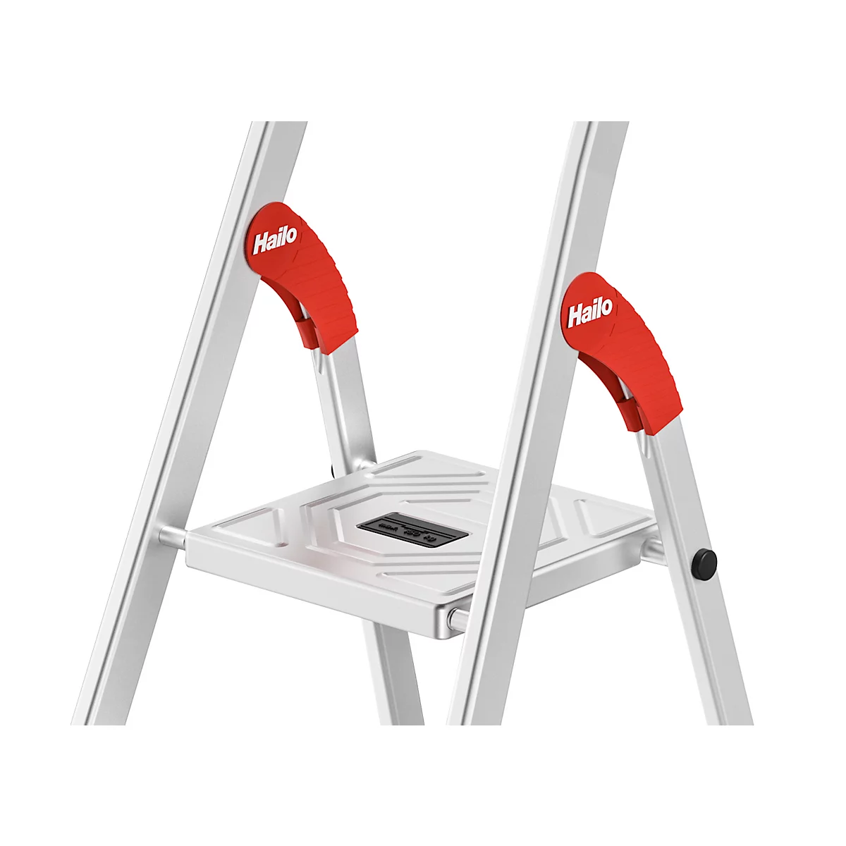 Close-up of a silver step ladder. Red handles with 'Hailo' lettering. Top step. Gray background.