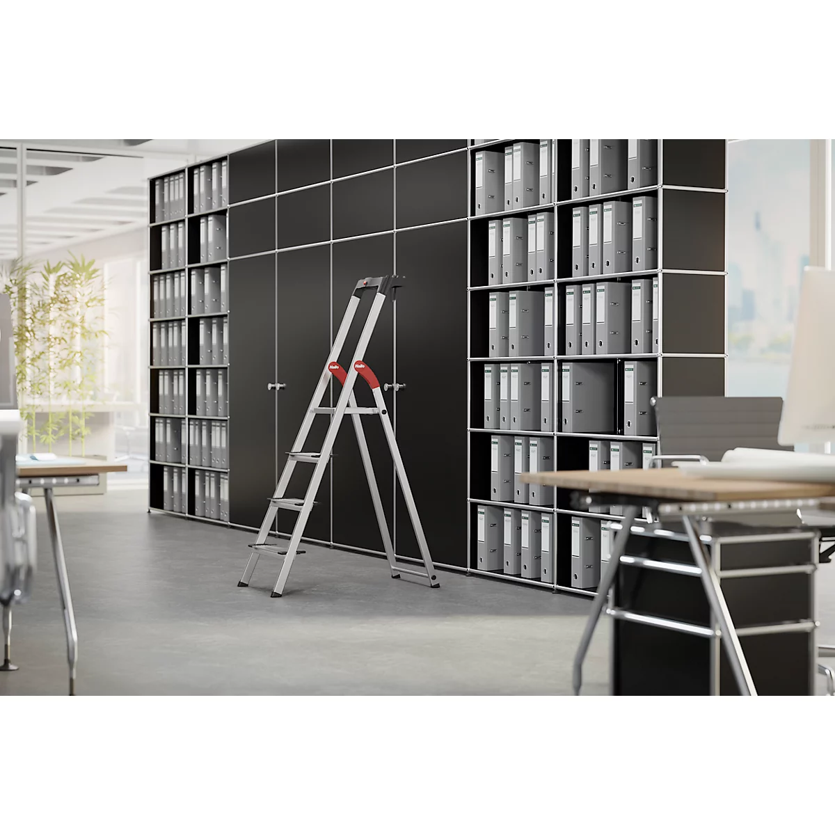 A stepladder stands in front of black file cabinets filled with folders. Office desks are in the background.