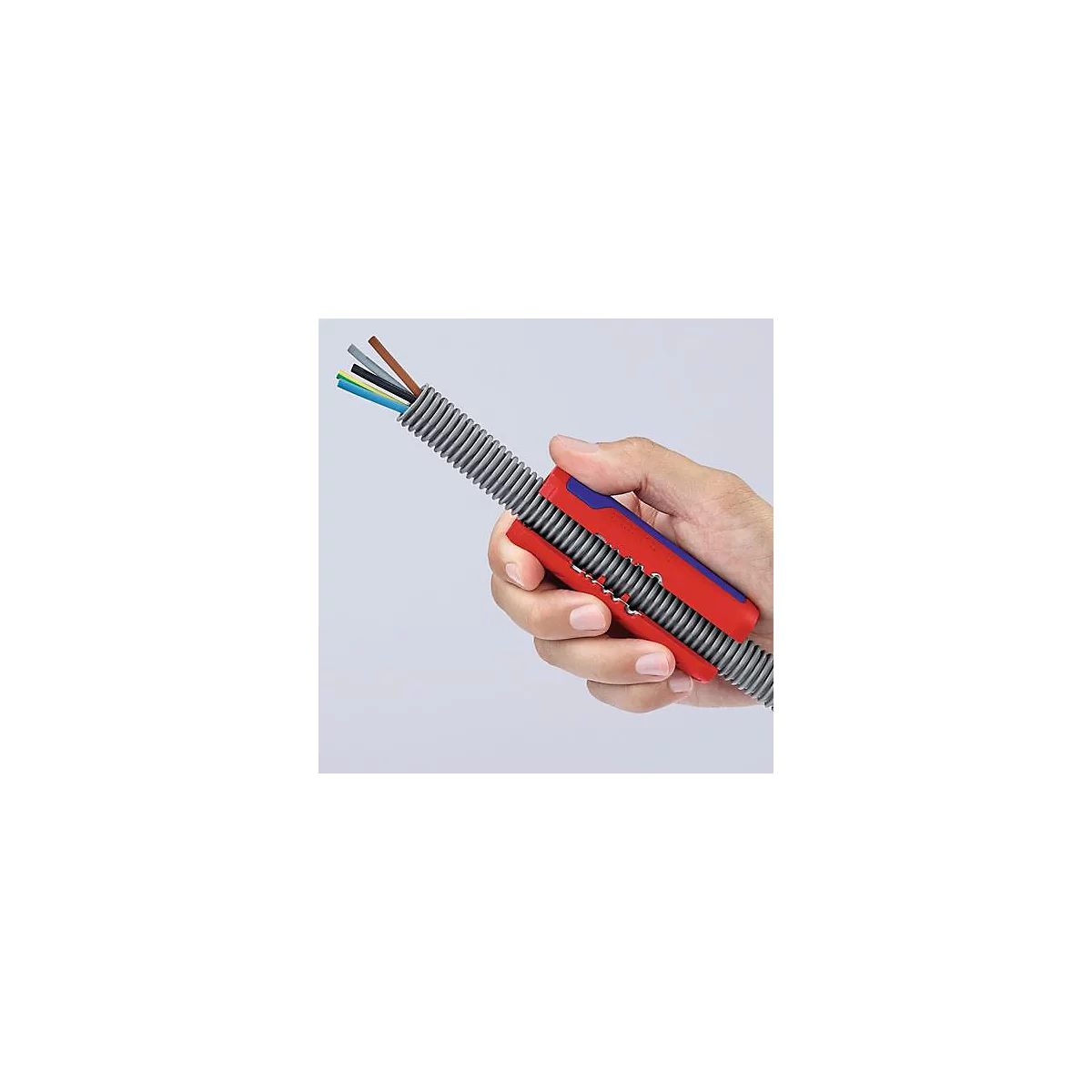 Hand houdt kabel vast met rood en blauw gereedschap, grijze gegolfde buis en gekleurde kabeluiteinden.
