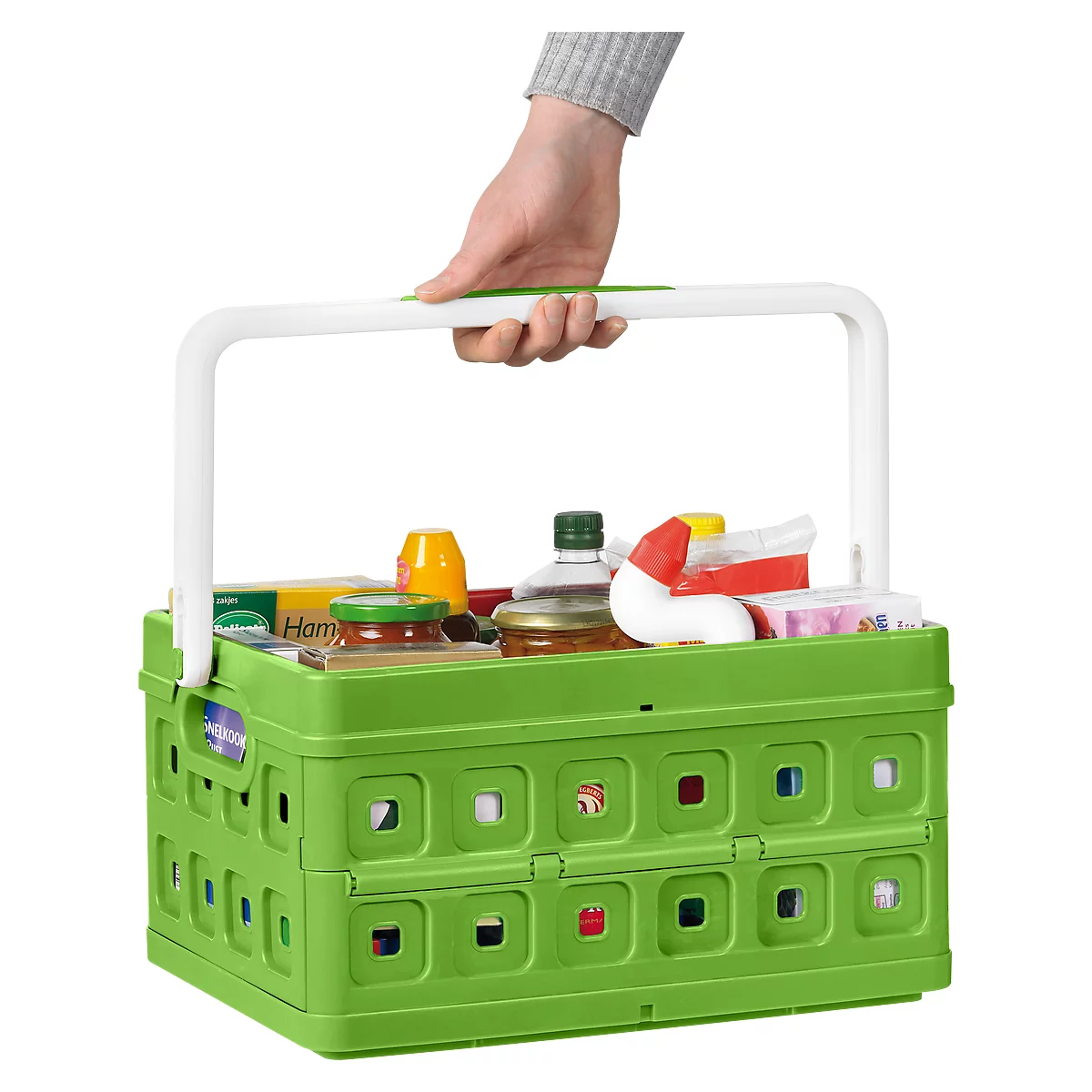 Green collapsible basket with groceries, held by a white handle.