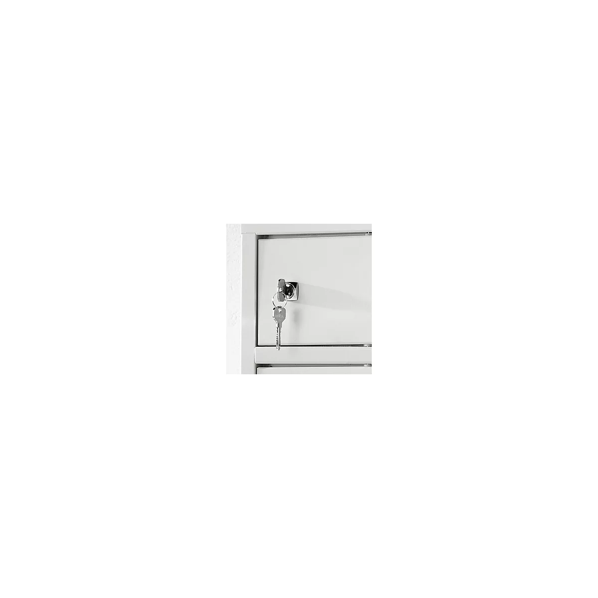 Close-up of a white cabinet with a key in the lock.