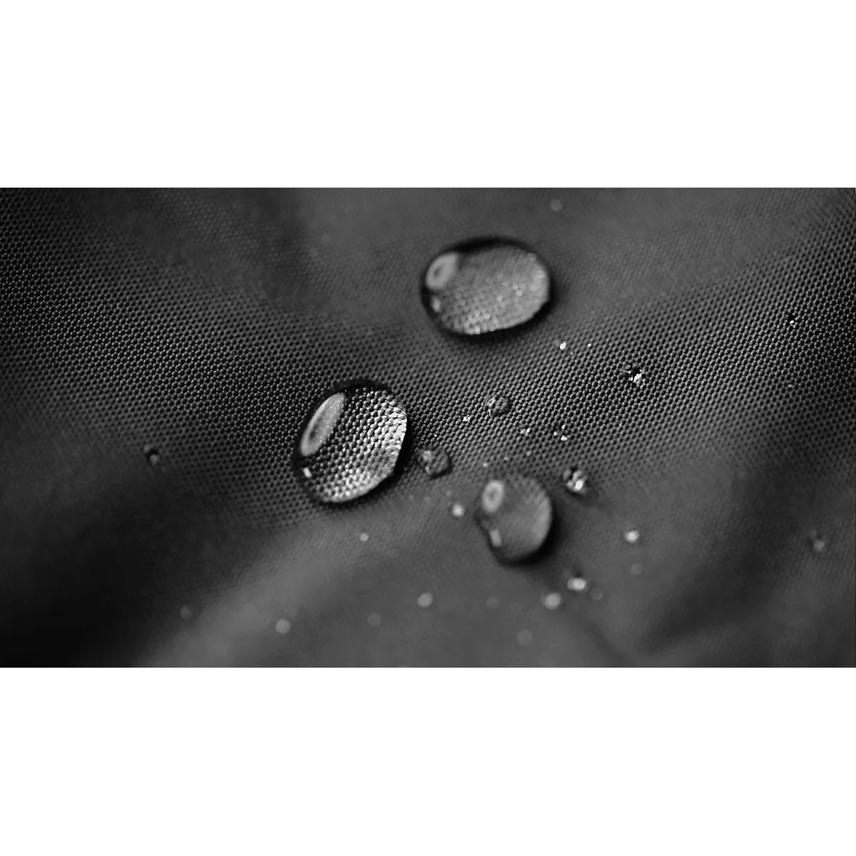 Close-up of black fabric with water droplets on the surface.