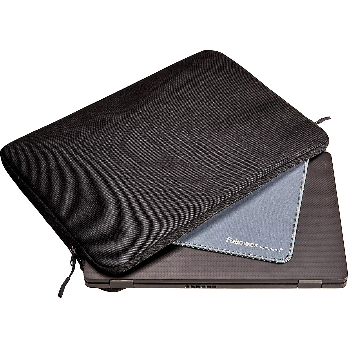 Souris sans fil sur un tapis de souris gris. En arrière-plan, un support pour ordinateur portable et un clavier.