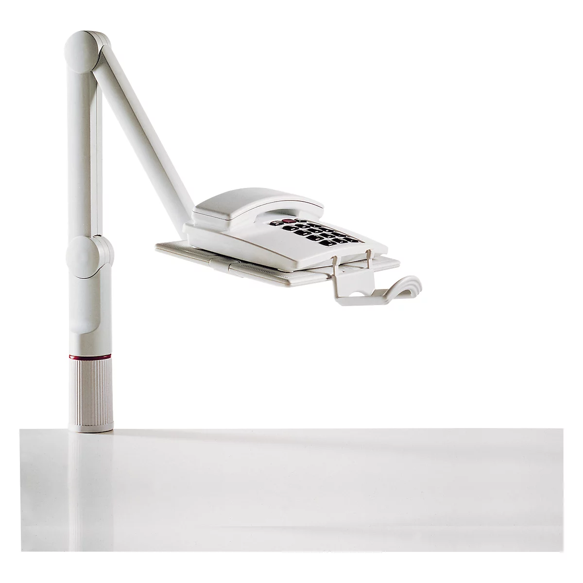 White phone with keypad, attached to a white, flexible bracket. On a light background.