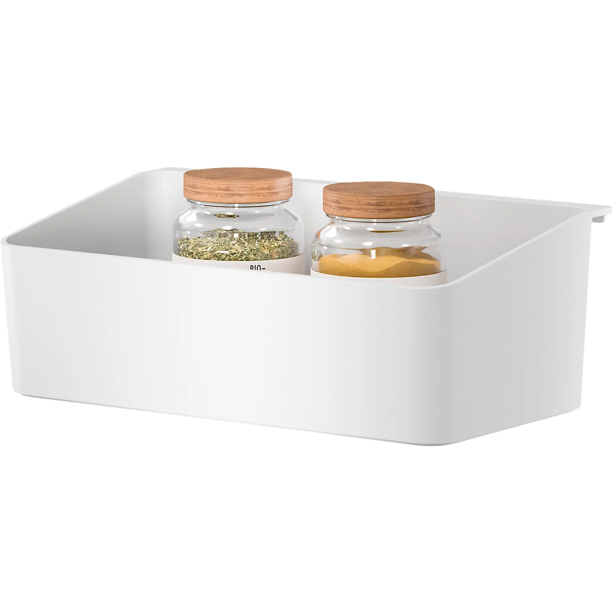 Panier de rangement blanc avec deux pots d'épices. Un pot contient des herbes vertes, l'autre de la poudre jaune.
