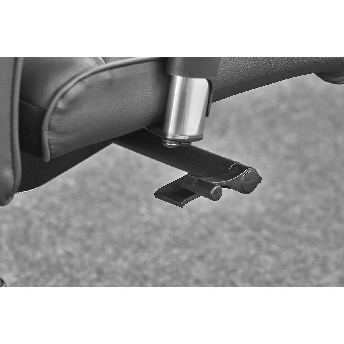 Detail shot of a chair. The metal arm, seat, and a lever are pictured. The lever is made of dark plastic.